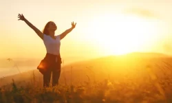 happy-woman-in-nature-at-sunset