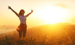happy-woman-in-nature-at-sunset